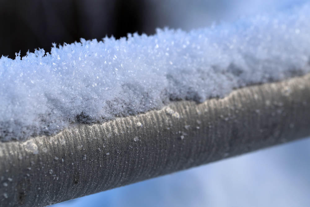 snow on exposed sewer pipes