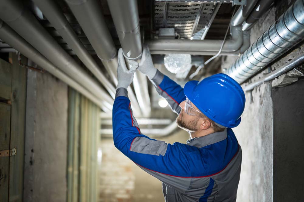 sewer contractor inspecting pipe