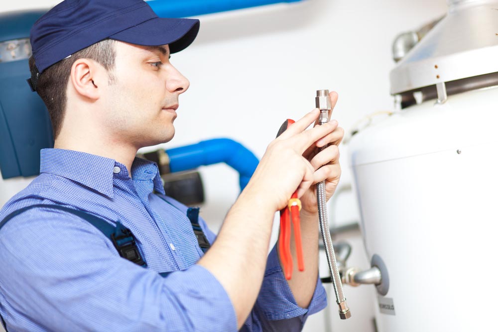 plumber fixing water heater