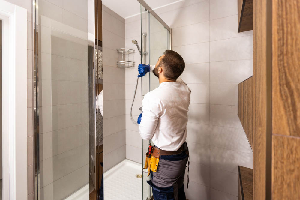 plumber in a remodeled bathroom
