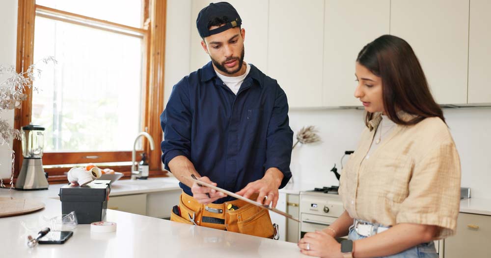 client talking to a sewer repair tech