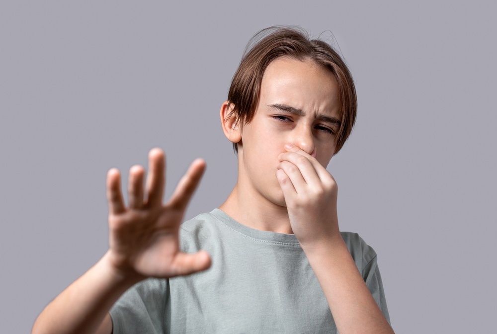 person covering their nose person covering their nose