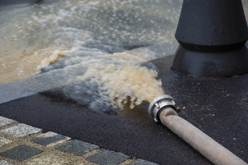 Pumping water in the flooded street after heavy rain and storms